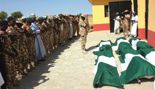 Some military men praying for the Metele fallen heroes before their burial, in Maiduguri on Friday