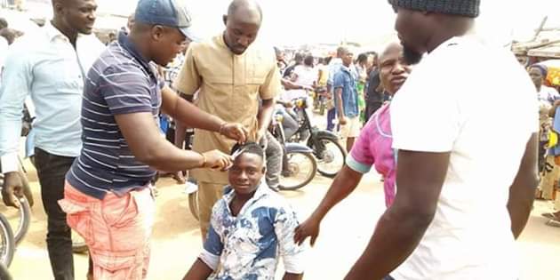 Photos: Outrage as youths storm market in Gboko, Benue and forcefully shaved young men with