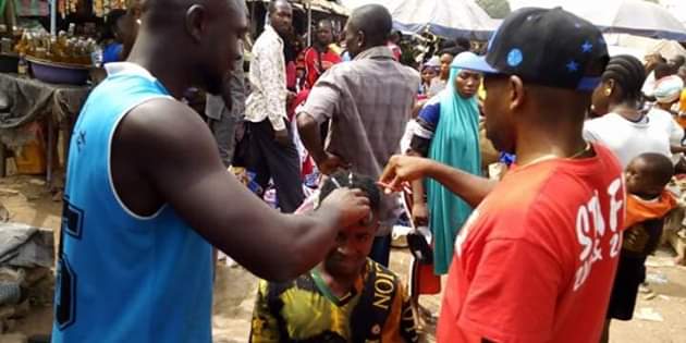 Photos: Outrage as youths storm market in Gboko, Benue and forcefully shaved young men with