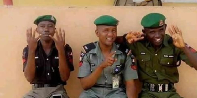 Police Officers doing Buhari's 4+4 sign