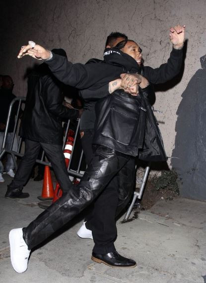 Photos: Tyga reaches for a gun after he was violently dragged out of Floyd Mayweather