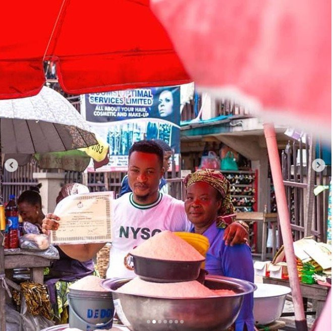 Graduate celebrates with his mother at the market after passing out of NYSC