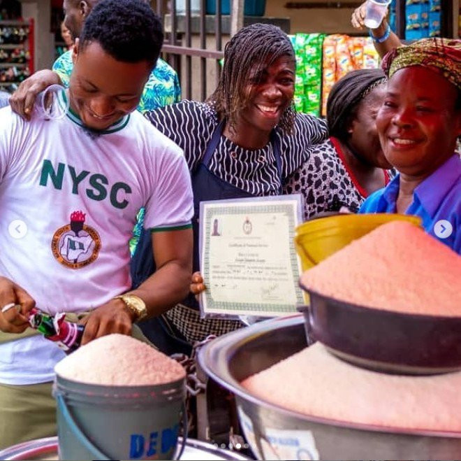 Graduate celebrates with his mother at the market after passing out of NYSC