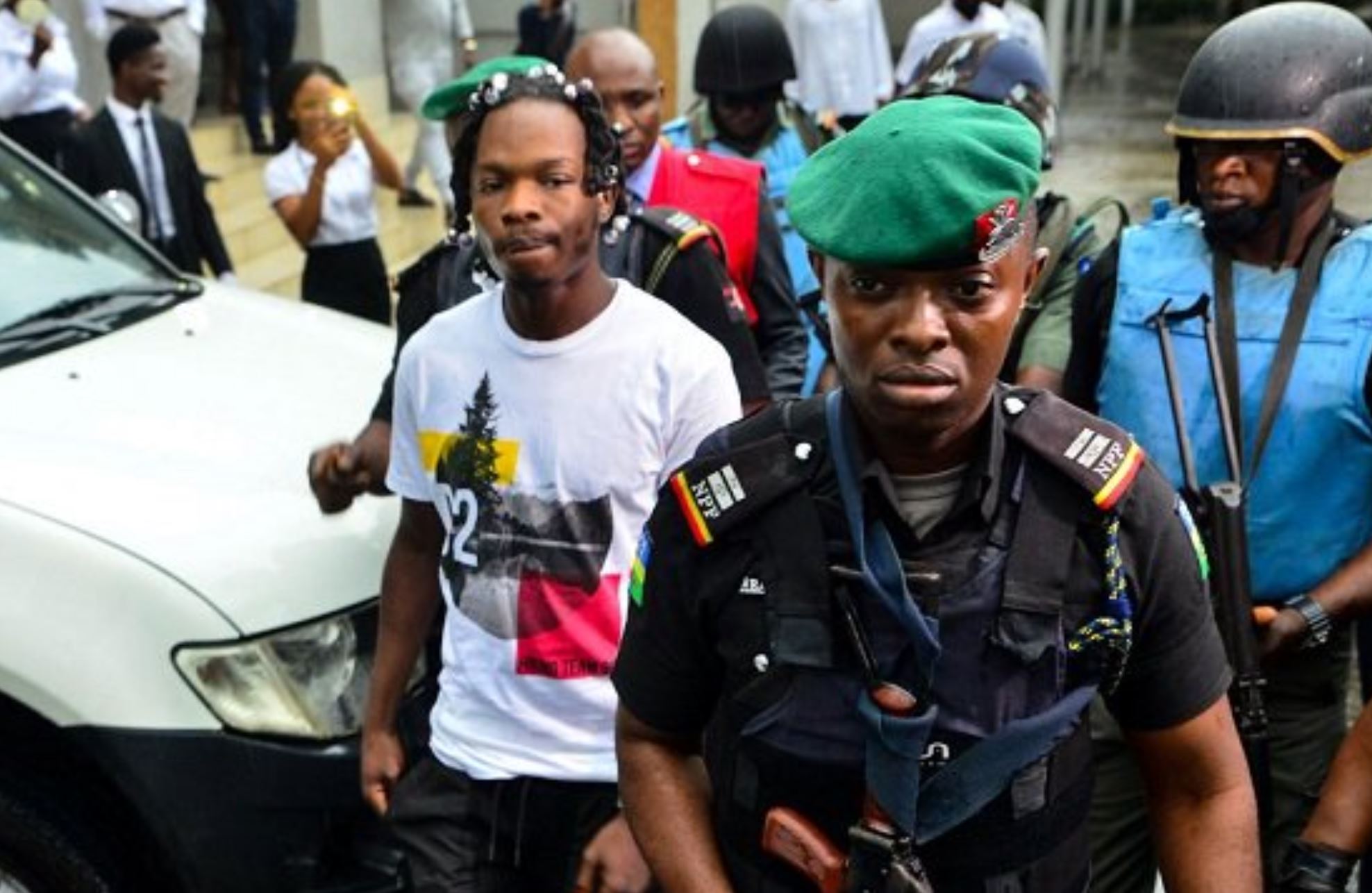 Image result for Naira Marley heavily guarded by Police