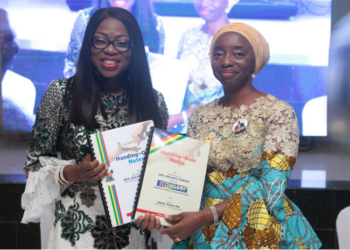 Wife of the Governor of Lagos State and chairman, Committee of Wives of Lagos State Officials (COWLSO), Mrs Bolanle Ambode (L) and wife of the Governor-elect, Dr. (Mrs.) Ibijoke Sanwo-Olu (R), displaying the handing-over documents after signing, during the handing-over ceremony wife of the in-coming governor, at the Lagos House, Alausa, Ikeja, over the weekend.