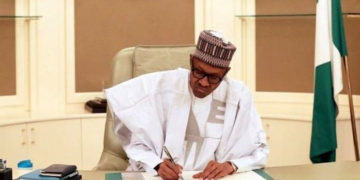 Buhari signing the N8.9trn 2019 Budget