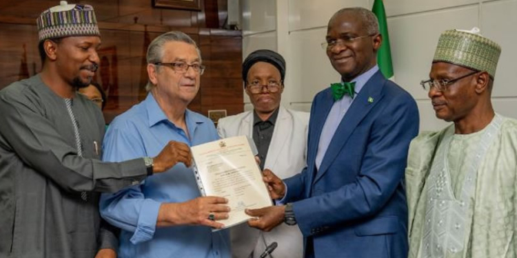 Super Eagles’ coach, Clemens Westerhof receiving documents of his house gift