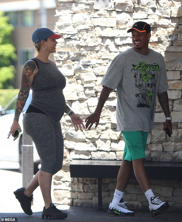 Amber Rose flaunts her growing baby bump during date with beau Alexander 