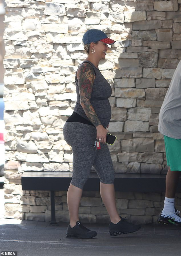 Amber Rose flaunts her growing baby bump during date with beau Alexander 