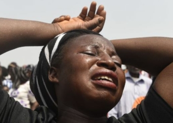 A woman cries during a funeral service