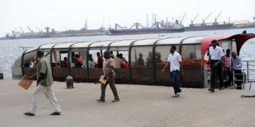 Passengers alight from a ferry in Lagos. Photographer: Pius Utomi Ekpei/AFP/