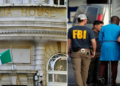The Nigerian embassy in Washington DC, FBI agents carrying away Nigerian fraudster