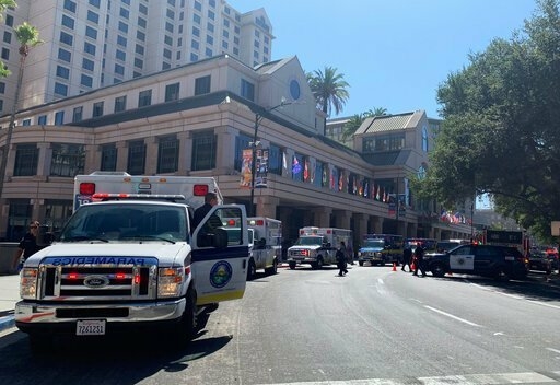 Fire crews gather on Market Street outside the Hotel Fairmont in downtown San Jose, Calif., after a report of a chemical odor Saturday, Aug. 31, 2019. Authorities say at least one woman has died and several people have been sickened in a hazmat incident Saturday at the Northern California hotel. (Nico Savidge/San Jose Mercury News via AP)