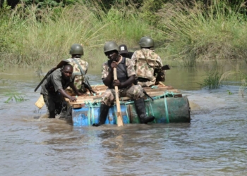 Troops paddling through Sambisa River