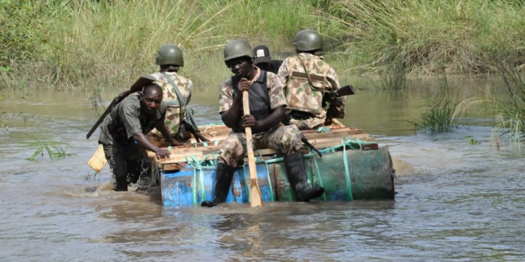 Troops paddling through Sambisa River