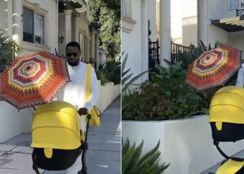 D’banj taking a walk with his new born