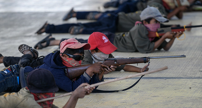Cross section of Mexican kids taking precision shots