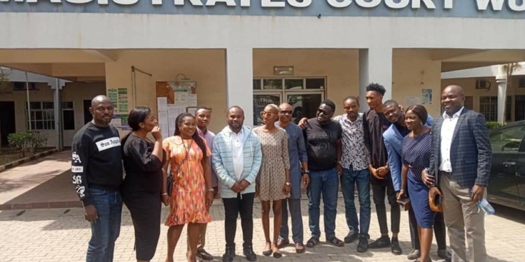 TheNigerian News Group journalists, Pricilla Ajeshola, Jacob Orji, Abayomi Adedoyin, Peggy Shande and David Gold Enemingin with their colleagues in-front of Magistrate court in Abuja after they were granted bail