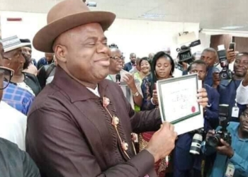 Senator Duoye Diri displaying his INEC certificate