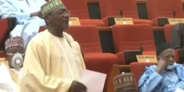 Moment a Nigerian Senator removed his face mask to sneeze during plenary
