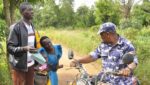 Woman kneels down begging police officers not to confiscate motorcycle of a rider carrying sick child