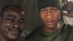 PHOTOS: Soldier appreciated by Nigerian man after helping him to repair his faulty car in the rain