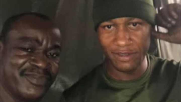 PHOTOS: Soldier appreciated by Nigerian man after helping him to repair his faulty car in the rain