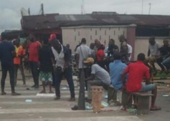 Youths cook with firewood in front of Shell company as they protest sacking of their kinsmen in Rivers