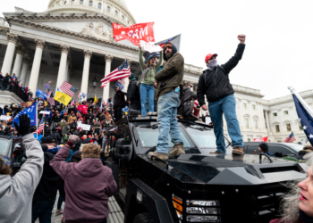 UNITED STATES - JANUARY 6: Trump supporters stand on the U.S. Capitol Police armored vehicle as others take over the steps of the Capitol on Wednesday, Jan. 6, 2021, as the Congress works to certify the electoral college votes. (Photo By Bill Clark/CQ-Roll Call, Inc via Getty Images)