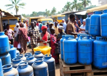 Cooking gas cylinders at Nigerian market with people nearby.
