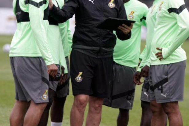 Football coach reviewing match information during training