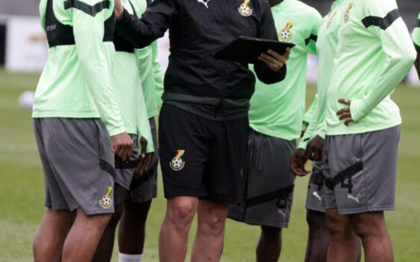 Football coach reviewing match information during training