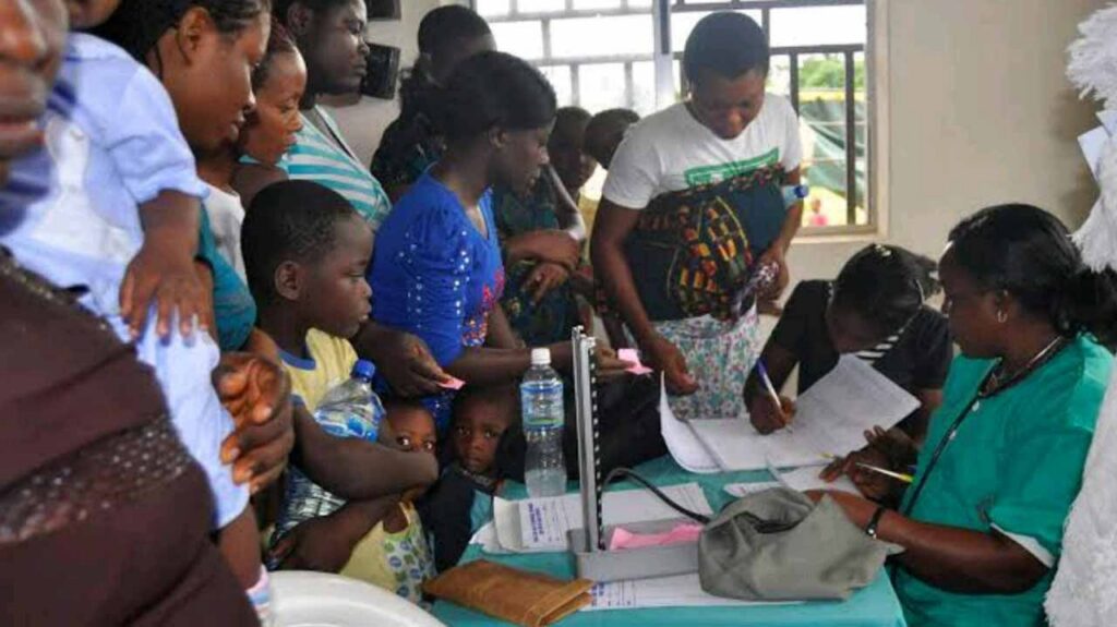 Nigerian family speaking with a healthcare professional about health insurance coverage in Lagos