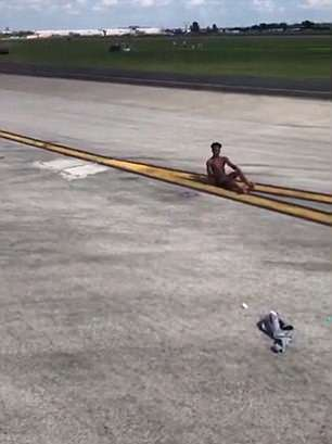Half-naked man sprints toward Delta Air Lines plane at Atlanta airport after he jumped out of his plane and climbed onto the wing of another (video)
