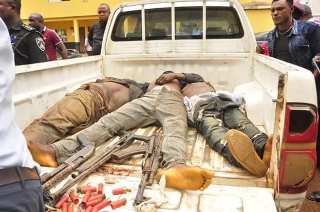 Police parade corpses of three armed robbers killed during foiled bank robbery attack in Edo